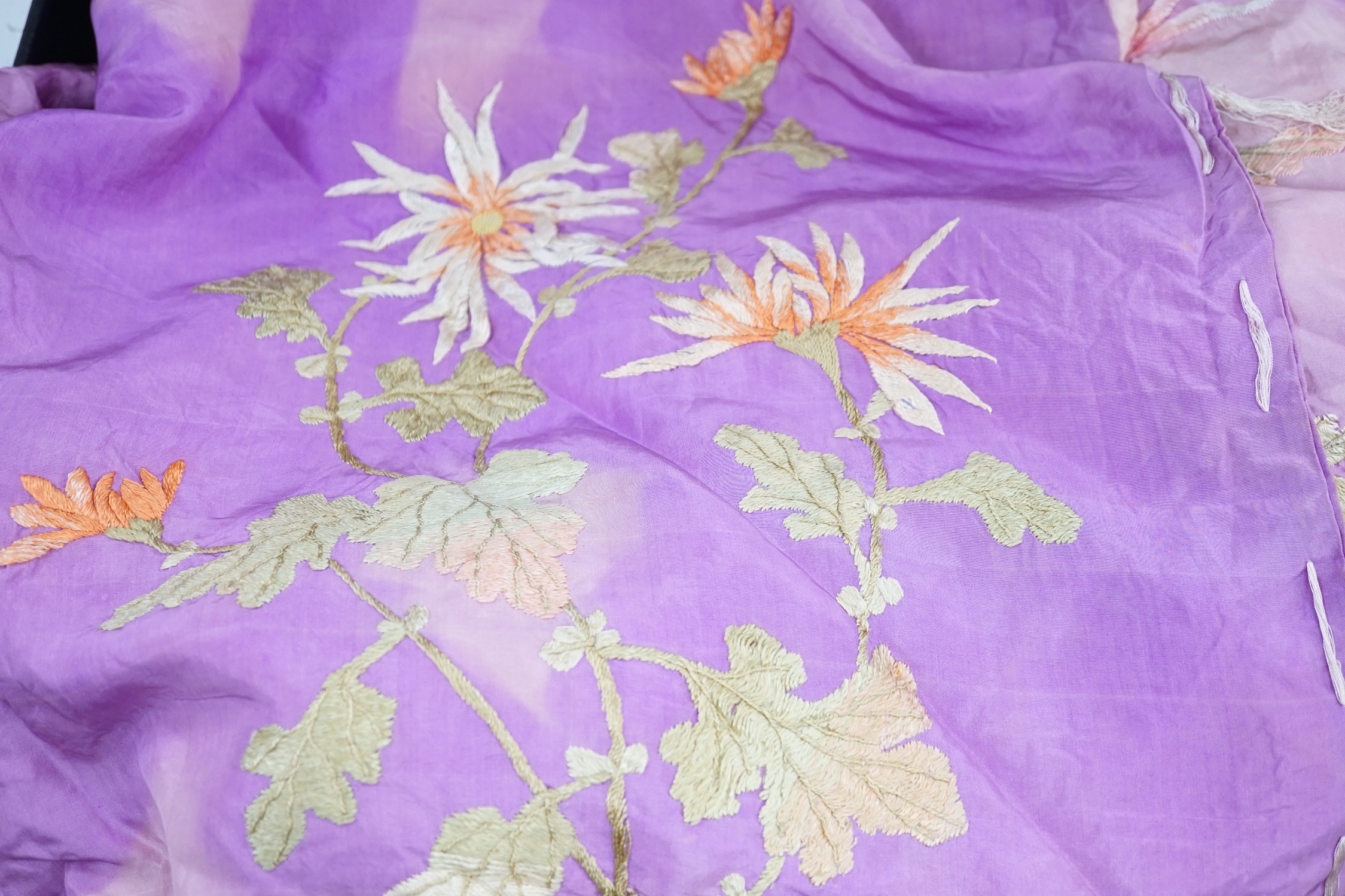 A Japanese silk kimono embroidered on mauve silk with multi-coloured butterflies and flowers, together with a cream silk unmade up kimono richly embroidered with a dragon design